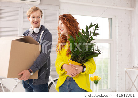 Joyful optimistic couple living together Joyful optimistic couple living together 41618391