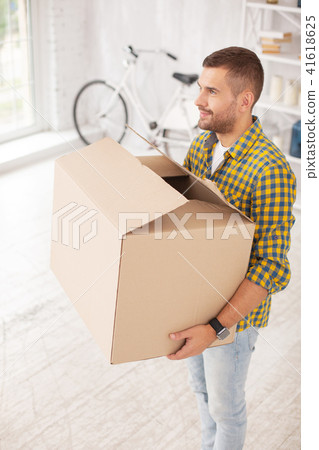 Happy glad man moving in apartment Happy glad man moving in apartment 41618625