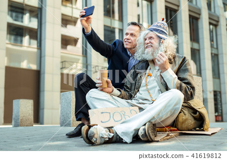 Influencing businessman asking other people for helping homeless Influencing businessman asking other people for helping homeless 41619812