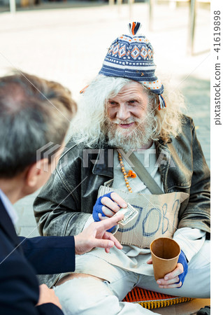 Unemployed elderly hippy man begging for help 41619898