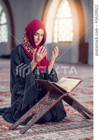 Young muslim woman praying with rosary in mosque 41620922