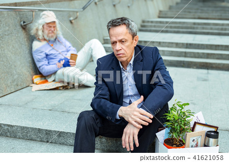 Dismissed office manager sitting on the stairs 41621058