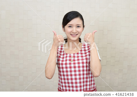 A woman with a smile wearing an apron 41621438