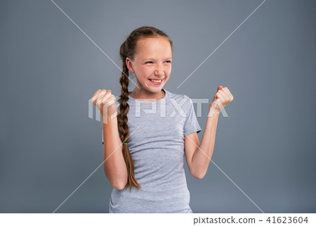 Overjoyed teenage girl doing fist pumps Overjoyed teenage girl doing fist pumps 41623604