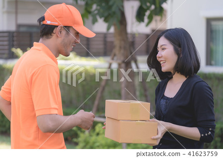 Woman receiving a delivery box from delivery man Woman receiving a delivery box from delivery man 41623759