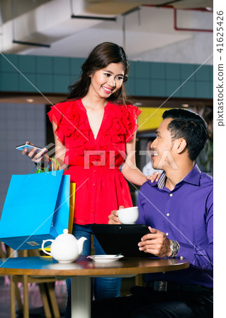 Beautiful young woman holding three shopping paper bags Beautiful young woman holding three shopping paper bags 41625426