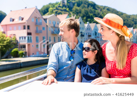 Family on river cruise in summer sitting in ship Family on river cruise in summer sitting in ship 41625449