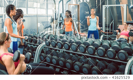 Strong and beautiful women exercising with dumbbells for toned arms 41625529