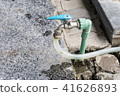 Garden hose or white rubber tube with faucet on gr 41626893