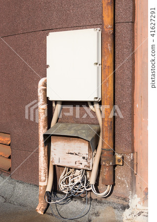 Old electrical cabinet and wires on wall. 41627291