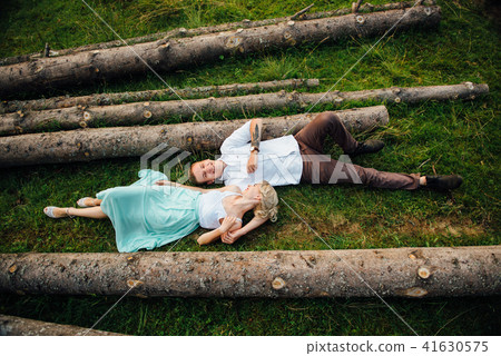 couple in love walking near logs in the mountains 41630575