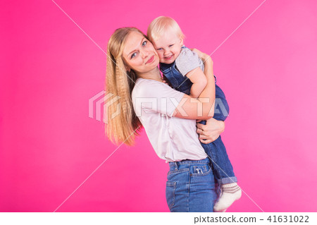 Funny family on pink background. Mother and her daughter girl. Mom and child are having fun. 41631022