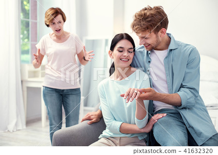 Pleasant nice man sitting with his fiancee Pleasant nice man sitting with his fiancee 41632320