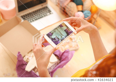 Freelance needlewoman taking pictures for her online shop Freelance needlewoman taking pictures for her online shop 41634021