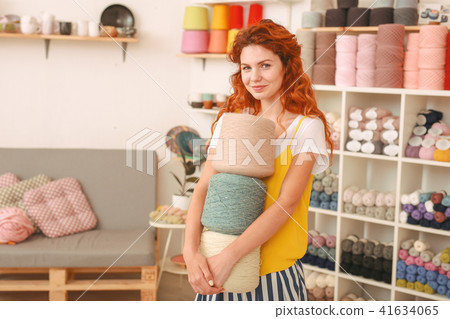 Young creative girl coming to textile shop Young creative girl coming to textile shop 41634065
