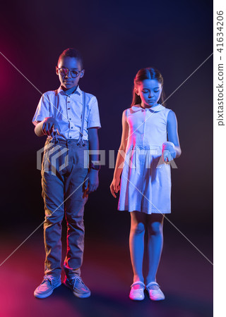 Concentrated kids pressing imaginary buttons 41634206