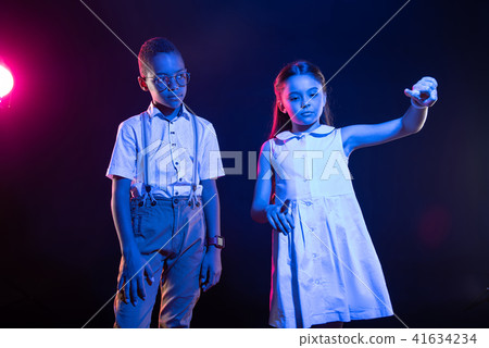 Serious girl pressing imaginary buttons 41634234