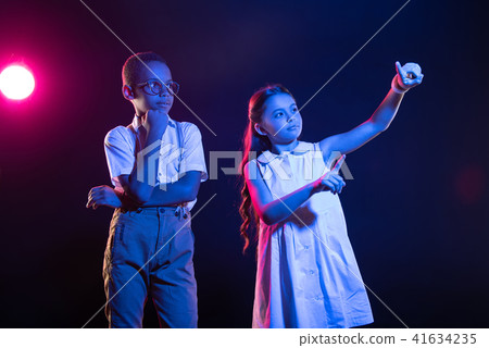 Cheerful girl pressing imaginary buttons 41634235