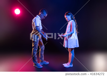 Inspired girl and a boy playing an imaginary piano 41634272