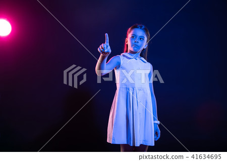 Dark-eyed girl pressing an imaginary button 41634695