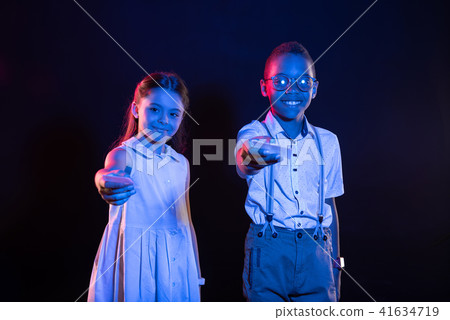 Smiling children holding their phones Smiling children holding their phones 41634719