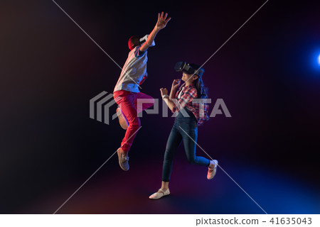 Joyful girl and a boy wearing VR headsets 41635043