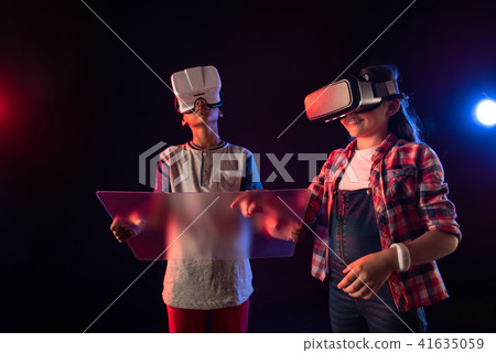 Pleased girl and a boy wearing VR headsets 41635059