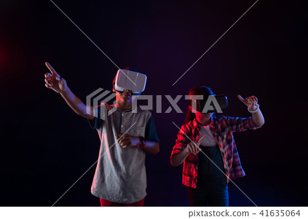 Serious girl and a boy wearing VR headsets 41635064