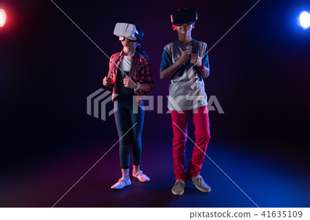 Delighted schoolchildren playing VR games together 41635109