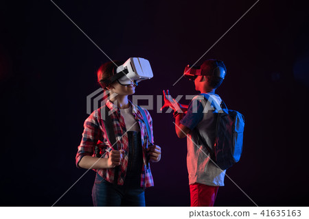 Inspired girl wearing a VR headset 41635163