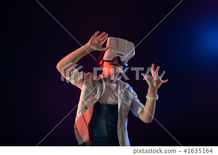 Joyful girl wearing a VR headset 41635164