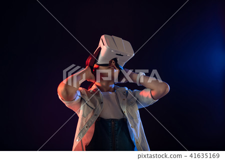 Serious girl wearing a VR headset Serious girl wearing a VR headset 41635169