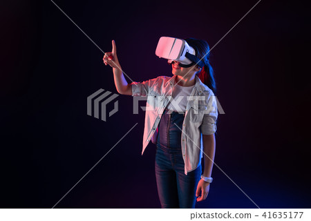 Delighted girl wearing a VR headset 41635177