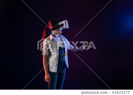 Happy schoolgirl wearing a VR headset 41635277