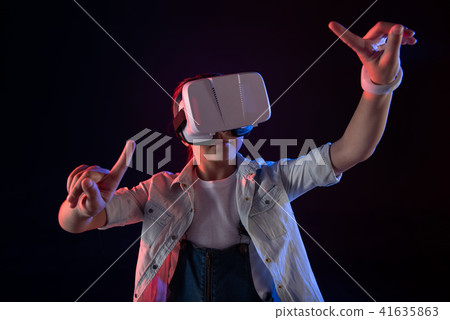 Determined schoolgirl wearing a VR headset 41635863