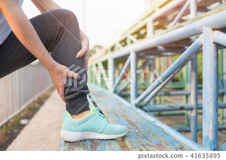 Young woman stretching her legs before running 41635895