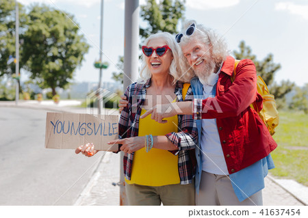 Positive aged man pointing at the sign Positive aged man pointing at the sign 41637454