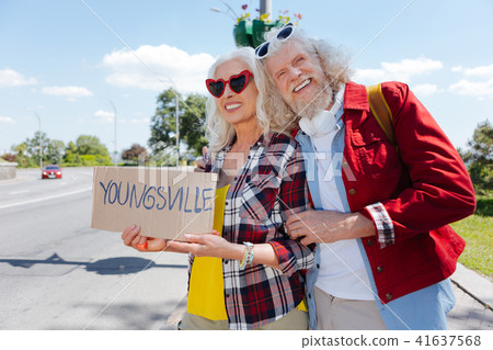 Delighted positive couple travelling together Delighted positive couple travelling together 41637568