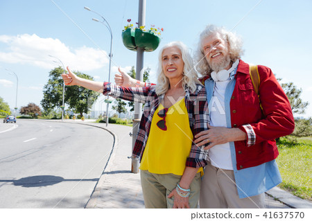 Aged hippy couple asking for a ride Aged hippy couple asking for a ride 41637570
