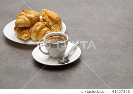Cup of fresh coffee with croissants Cup of fresh coffee with croissants 41637806