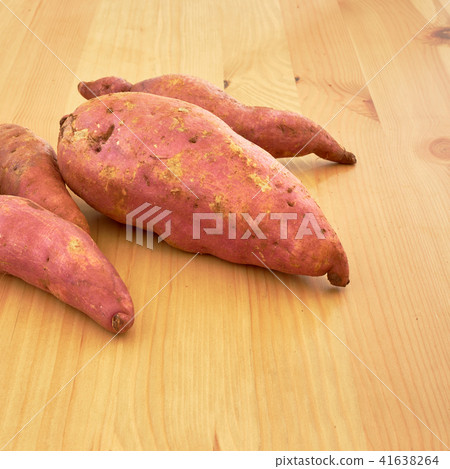 Sweet potatoes on a rustic wooden table Sweet potatoes on a rustic wooden table 41638264