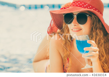 Happy young woman in swimsuit at swimming pool. Happy young woman in swimsuit at swimming pool. 41638314
