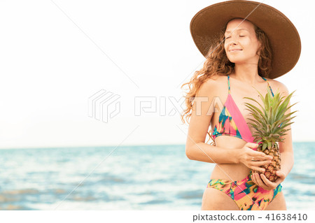 Happy woman wearing swimsuit on beach in summer Happy woman wearing swimsuit on beach in summer 41638410