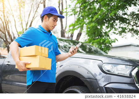 messenger man hold box and talk on smart phone and payment termi messenger man hold box and talk on smart phone and payment termi 41638824