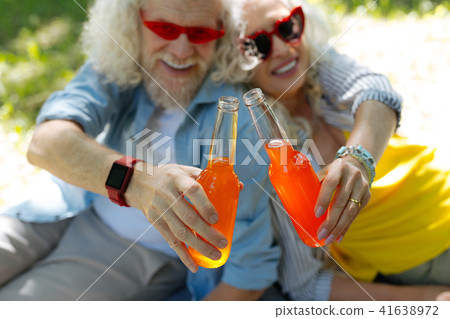 Selective focus of glass bottles clinked together Selective focus of glass bottles clinked together 41638972