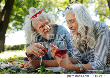 Positive nice woman holding a glass of wine Positive nice woman holding a glass of wine 41639159
