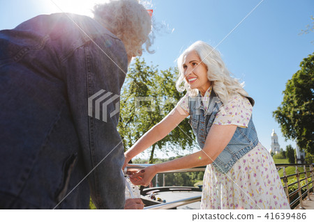 Positive joyful woman standing on the bridge 41639486