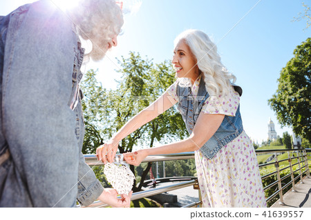 Happy joyful woman holding a heart Happy joyful woman holding a heart 41639557