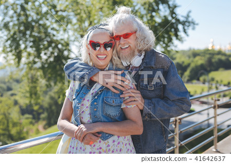 Delighted happy man standing behind his wife Delighted happy man standing behind his wife 41642637