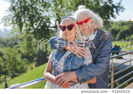 Nice positive man hugging his wife Nice positive man hugging his wife 41642638